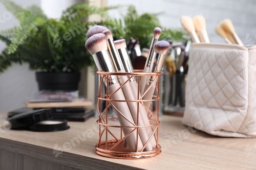 Preview: Makeup brushes in holder on wooden vanity indoors