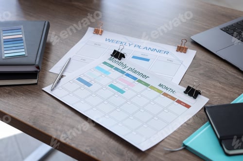 Preview: Planners, laptop and stationery on wooden desk