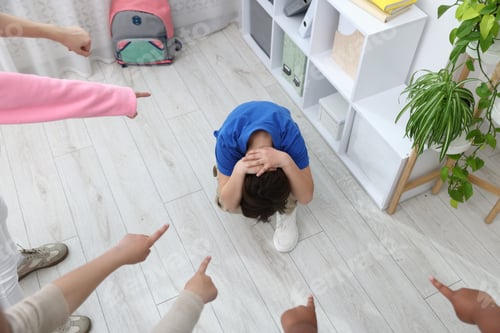 Preview: Boy getting bullied by his classmates in classroom, above view