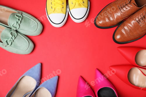 Preview: Different pairs of stylish shoes on red background, flat lay. Space for text