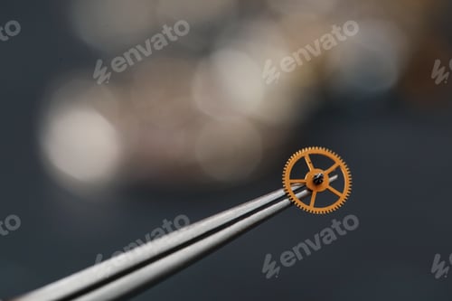Preview: Tool with wrist watch wheel on blurred background, closeup