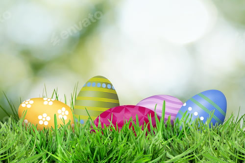 Preview: Easter eggs in green grass against blurred background