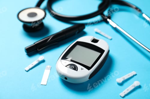 Preview: Diabetes. Digital glucometer, test strips, lancets and pen on light blue background, closeup