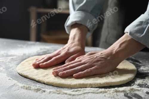 Preview: Woman making pizza dough at table, closeup