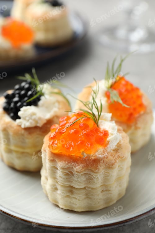 Preview: Tasty puff pastries with cream cheese, caviar and dill on table, closeup