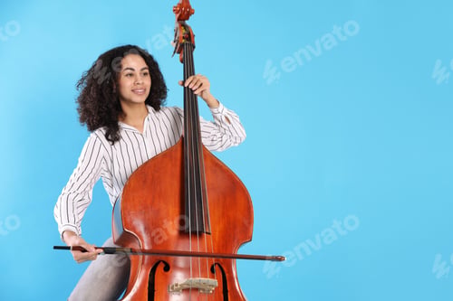Preview: Woman playing double bass on light blue background