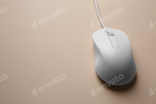 Preview: One wired mouse on beige background, closeup. Space for text