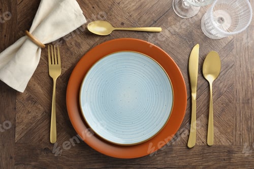 Preview: Stylish setting with cutlery, glasses and plates on wooden table, flat lay