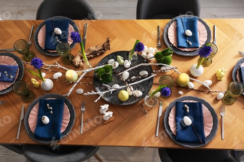 Preview: Easter celebration. Festive table setting with flowers and painted eggs indoors, flat lay