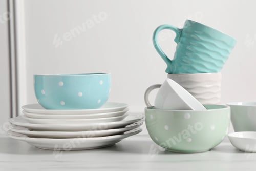 Preview: Beautiful ceramic dishware and cups on white marble table