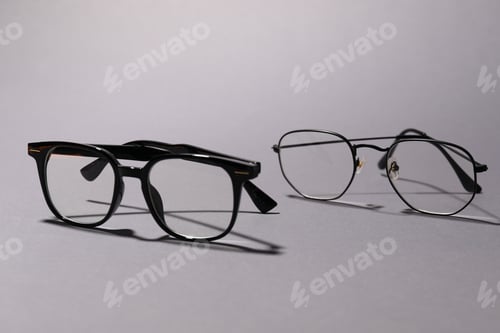 Preview: Pairs of eyeglasses on grey background, closeup