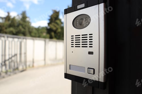 Preview: Modern intercom system on gate outdoors, closeup. Space for text