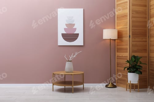 Preview: Stylish furniture, houseplant and lamp near brown wall indoors. Interior design