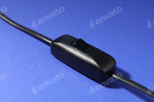 Preview: Inline cord switch for lamp on blue background, closeup