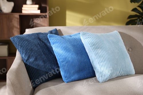 Preview: Soft pillows on grey sofa near green wall indoors