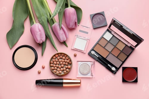 Preview: Spring composition with different makeup products and tulip flowers on pink background, flat lay
