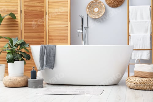 Preview: Stylish bathroom mat with pattern near bathtub on floor indoors. Interior design