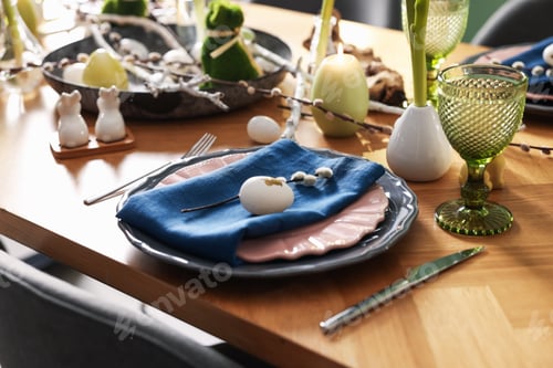 Preview: Easter celebration. Festive table setting with flowers and painted eggs indoors, closeup