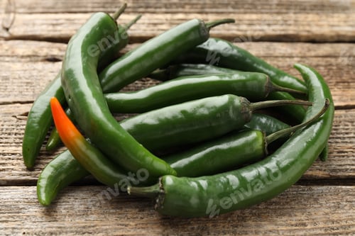 Preview: Fresh green chili peppers on wooden table, closeup