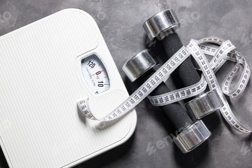 Preview: Dumbbells, measuring tape and scales on grey textured background, flat lay