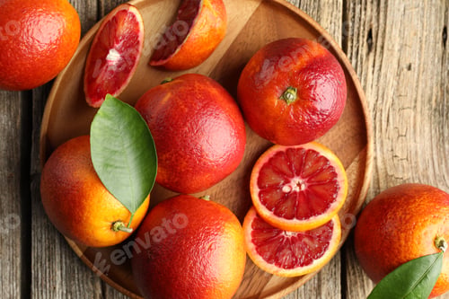 Preview: Fresh Sicilian oranges and green leaves on wooden table, flat lay
