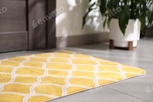 Preview: Beautiful doormat on floor near entrance indoors, closeup