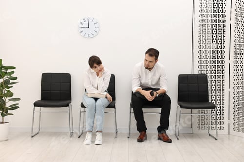 Preview: Man and woman waiting for job interview indoors