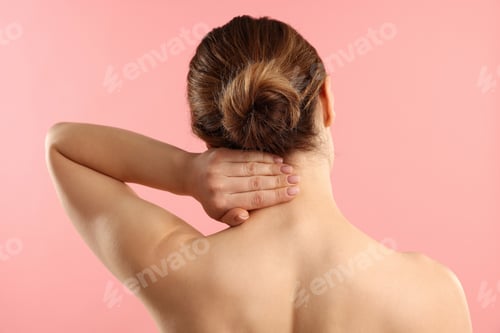 Preview: Woman doing neck massage on pink background, back view