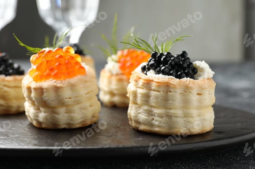 Preview: Tasty puff pastries with cream cheese, caviar and dill on table, closeup
