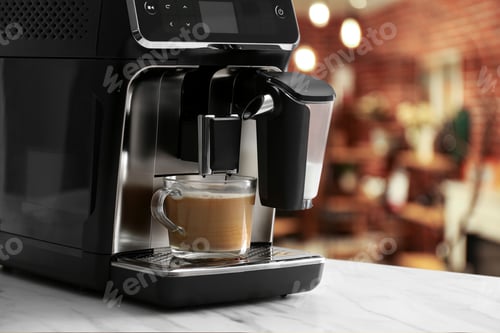 Preview: Coffee machine with cup of hot beverage on table in cafe, closeup