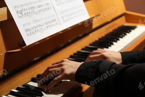 Preview: Musician playing piano indoors, closeup. Musical instrument