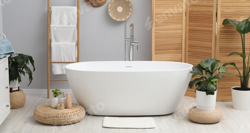 Preview: Stylish white bathroom mat near bathtub on floor indoors