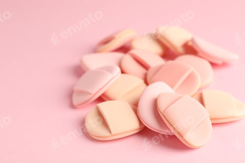 Preview: Clean makeup sponges on pink background, closeup. Space for text