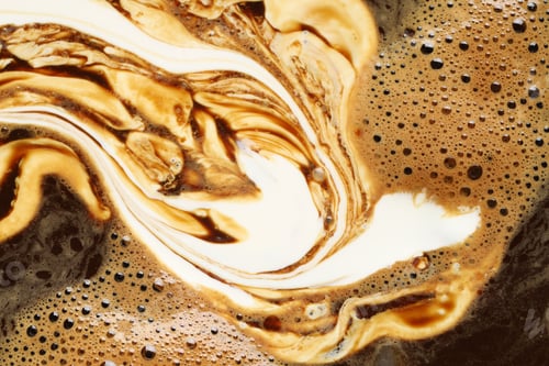Preview: Delicious coffee with milk and bubbles as background, top view