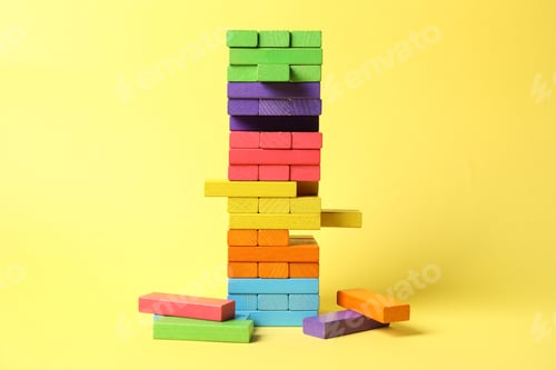 Preview: Tower of colorful blocks on yellow background