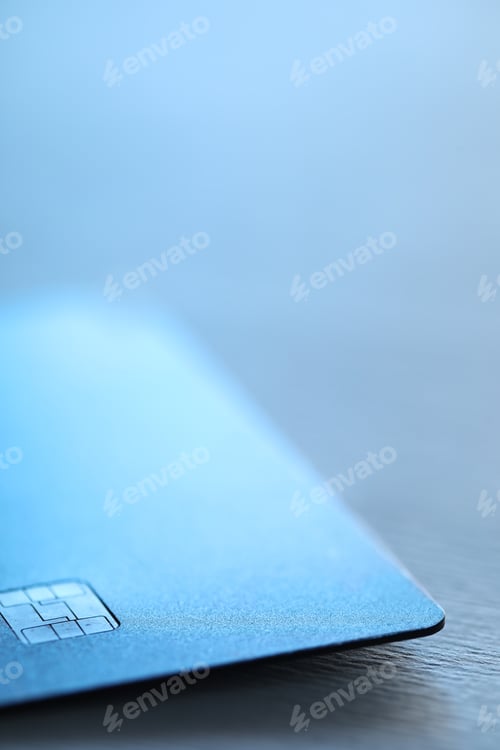 Preview: One credit card on blurred background, macro view. Space for text