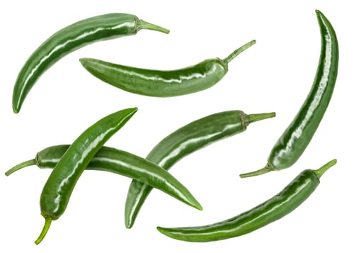 Preview: Green chili peppers flying in air on white background