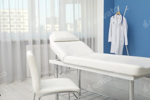 Preview: Examination table and chair in modern clinic. Interior design