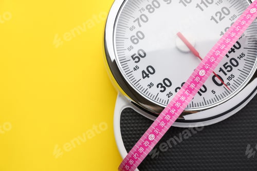 Preview: Scales with measuring tape on yellow background, top view. Space for text