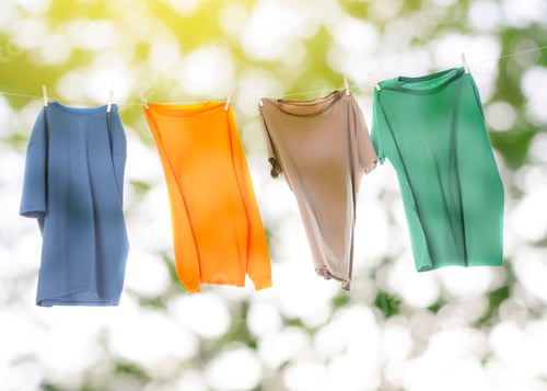 Preview: Clothes drying on laundry line outdoors against blurred tree during sunny day