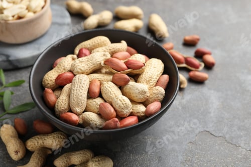 Preview: Fresh unpeeled peanuts in bowl on grey table