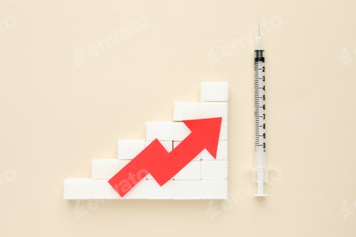 Preview: Diabetes control. Sugar cubes with arrow showing high blood sugar level and syringe on beige backgro