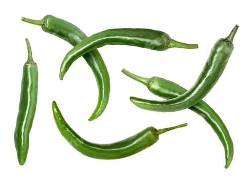 Preview: Green chili peppers flying in air on white background
