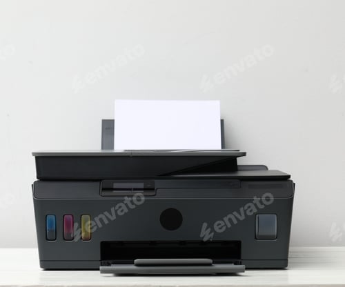 Preview: One black printer with sheet of paper on white wooden table near light grey wall, closeup