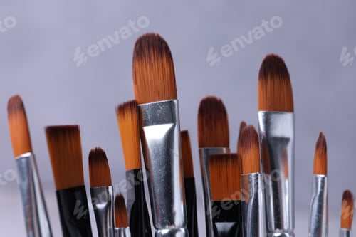 Preview: Paint brushes on light grey background, closeup