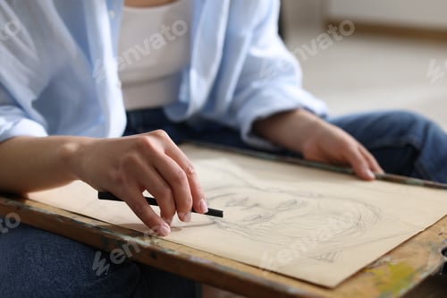 Preview: Woman drawing picture with charcoal in studio, closeup