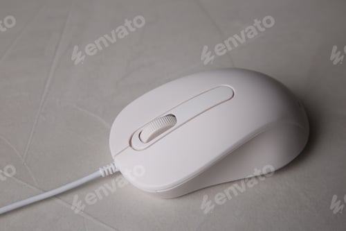 Preview: One wired mouse on grey textured table, closeup