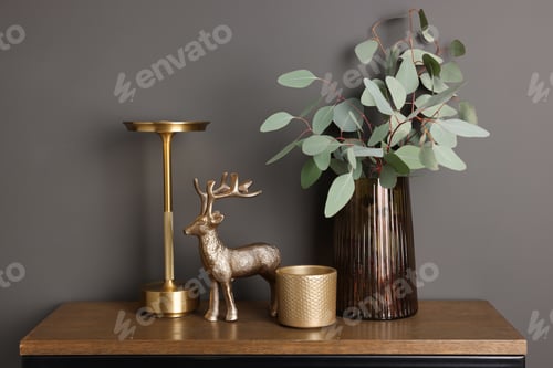 Preview: Beautiful vase with eucalyptus and other decor on wooden table near grey wall