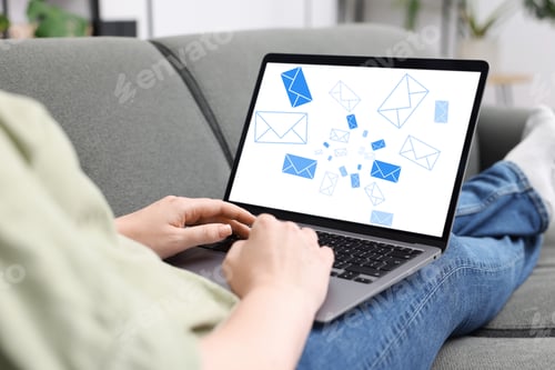 Preview: Woman sending or receiving email on laptop at home, closeup. Letters on computer screen