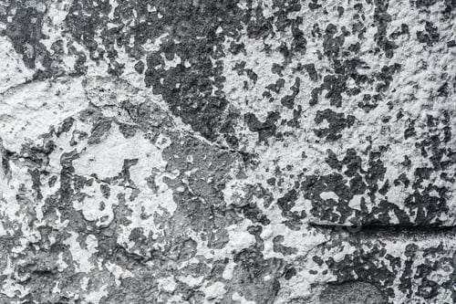 Preview: Rough stone surface with peeling white paint. Textured background.